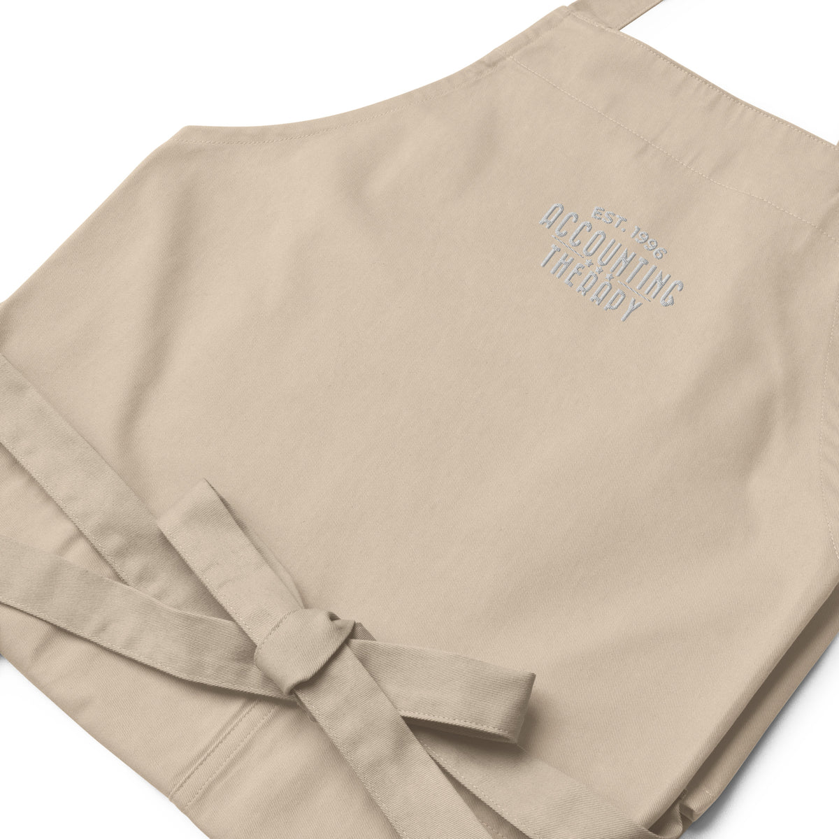 Product mockup - Close-up of organic cotton apron in off white showing rope neck strap detail and textured fabric stitching